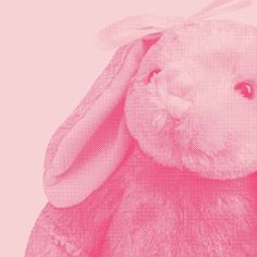 a pink bunny rabbit sitting in front of a pink background