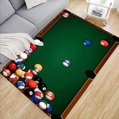 a pool table with billiards and balls on it in a living room area