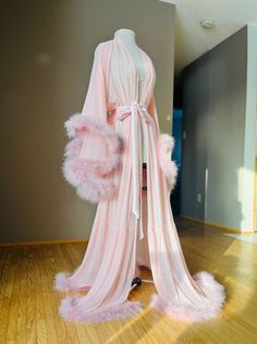 "Long pink sheer marabou feather robe with satin sash (photo shows built in style). Beautiful for boudoir, bridal and maternity shoots! Also just nice for a romantic night, getting ready or lounging at home! PLEASE MSG ME YOUR HEIGHT IF YOU REQUIRE TALLER THAN 5'8\" WITH HEELS/SHOES Comes in all colors and sizes (message for info). All of these are handmade to order. For custom color requests please allow time for me to get materials and make it." Husband Killer Robe, Oakley Core, Fur Edged Robe, Long Robes For Women, Fluffy Dressing Gown Aesthetic, Sheer Fur Trimmed Robe, Pink Fluffy Robe Aesthetic, Pink Robe With Fur, Fur Aesthetic