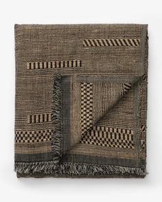 a black and brown blanket with fringes on it