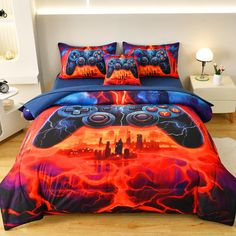 a bed covered in a blue and red comforter next to a night sky scene