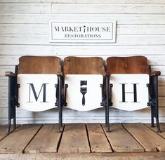 three chairs sitting on top of a wooden floor next to a sign that says market house restorations