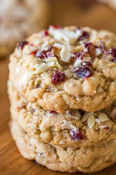 three cookies with cranberries and almonds stacked on top of eachother