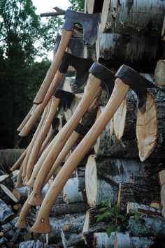 several pieces of wood stacked on top of each other with axes stuck to them in the middle