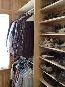 a closet filled with lots of shoes next to a window