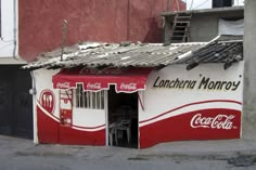 a coca - cola store on the side of a building