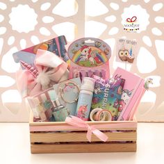 a wooden box filled with lots of toys and items on top of a white table