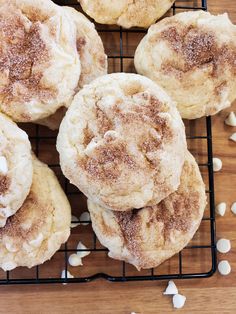 several sugar cookies are cooling on a wire rack