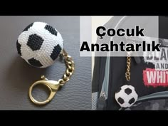 a handbag with a soccer ball hanging from it