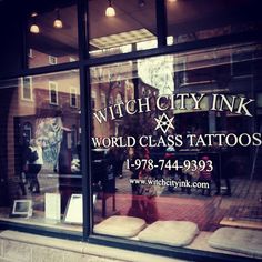 the window of a tattoo shop that has been closed for several years and is now open