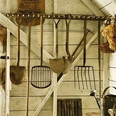 an old kitchen with utensils hanging from the ceiling and other items on the wall