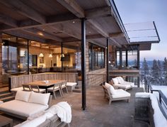 an outdoor living room and dining area with snow on the ground