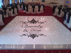 the dance floor is decorated with black and white ribbons