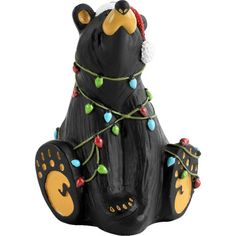 a black bear figurine with christmas lights on it