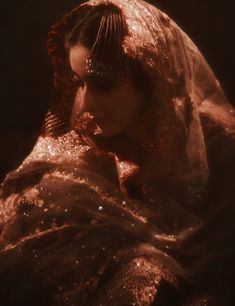 a woman wearing a gold veil and headdress