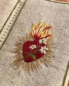 an embroidered heart on a piece of cloth