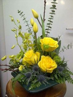 a vase filled with yellow flowers on top of a table