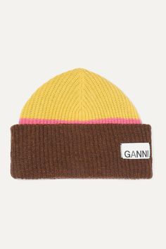 a beanie with the word ganni on it in brown, yellow and pink