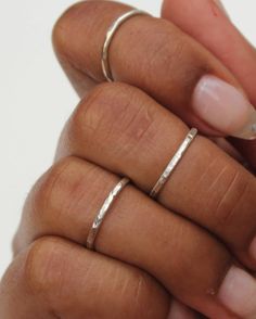 The Silver Hammered Stacking Ring Set features three soldered rings that are handmade to order. Each set includes three stackable rings that have a subtle shiny sparkle. These rings can be worn all together on one finger, and also look great spread out on multiple fingers. Available in midi and regular sizes. Please provide up to three sizes at checkout. If no size is provided, I'll make the rings in a general midi ring size (3, 4, 4.5) *Size comparison: a normal ring size 6 would usually fit a Adjustable Stackable Bands As Gift, Minimalist Metal Stackable Rings For Anniversary, Handmade Minimalist Round Band Jewelry, Minimalist Handmade Jewelry With Round Band, Handmade Stackable Toe Rings For Everyday, Handmade Everyday Stackable Toe Rings, Handmade Sterling Silver Stackable Rings For Everyday, Handmade Stackable Rings For Everyday Wear, Everyday Hand Forged Sterling Silver Stackable Rings