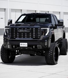 a black truck parked in front of a building