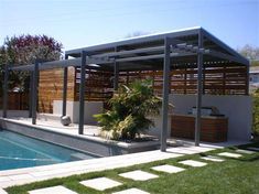 a backyard with a pool, hot tub and pergolated decking around it