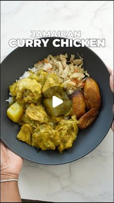 a person holding a plate full of food with the words jamaican curry chicken on it