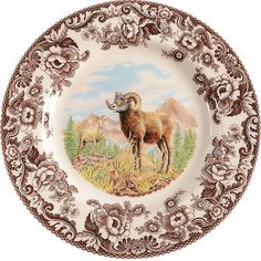 a plate with an image of a ram on it's side and mountains in the background