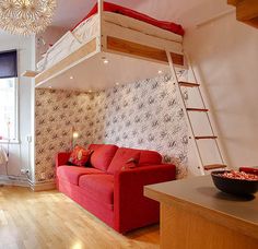 a living room filled with furniture and a loft bed above the couch in front of a window