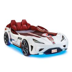 a white sports car with red seats and lights