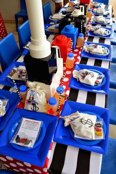 the table is set with blue and white plates, napkins, and other items