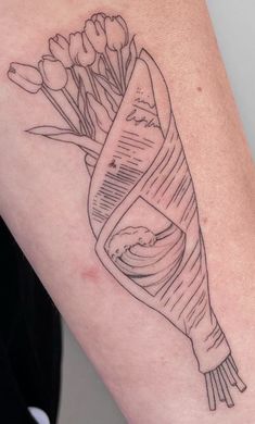 a woman's arm with a tattoo on it that has flowers growing out of it