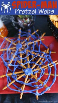 spider - man pretzel webbs on a red plate with blue sprinkles