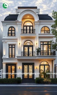 a large white house with lots of windows and balconies on the second floor