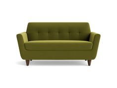 a green couch sitting on top of a white floor