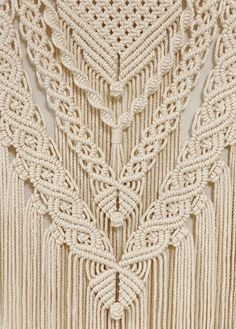 the crochet pattern is shown on top of a piece of cloth with fringes