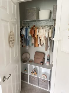 the closet is organized with clothes and other things to keep in order for baby's arrival