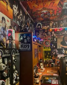 a room filled with lots of different items and posters on the walls, along with shelves full of memorabilia