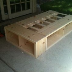 a wooden table sitting on top of a cement floor next to a door and window