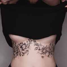 a woman's stomach with flowers on it and the bottom part of her body