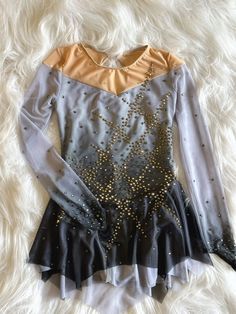 a woman's leotard dress with gold and silver sequins on it