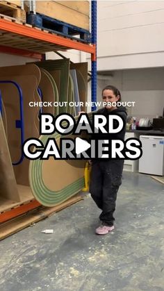 a man is standing in front of some cardboard boxes with the words board carriers on it