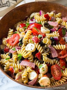 a bowl filled with pasta salad on top of a table