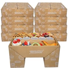 four cardboard boxes filled with different types of food on top of each other and the bottom one is empty