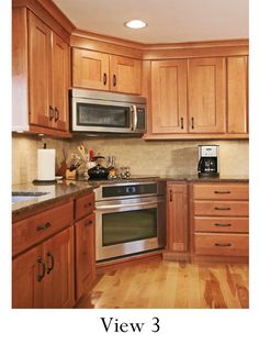 an image of a kitchen setting with wood cabinets and stainless steel stove top ovens