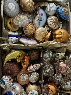 a box filled with lots of different colored ornaments