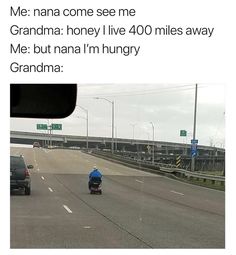 an image of a man driving down the road on his motorcycle in front of some cars