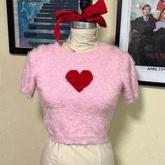 Brand New, Never Worn. Super Soft Fuzzy Pink Cropped Sweater With Red Heart On Chest. Short Sleeve With Round Neckline. Pink Heart-shaped Top For Valentine's Day, Cute Heart Print Tops For Winter, Trendy Red Top With Heart Print, Trendy Knit Tops With Heart Print, Trendy Heart Print Tops For Winter, Red Crew Neck Top With Heart Patch, Cute Knit Tops With Heart Print, Winter Knit Tops With Heart Print, Cute Fitted Top For Valentine's Day