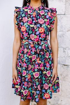 This bold dress is stunning! It's going to look so fabulous this spring and summer! This dress may have a black background but it doesn't make it any less perfect for the season! Those vibrantly colors flowers truly pop against it! This dress is going to look amazing with heels, sneakers, or sandals! Round neckline Button keyhole back Ruffled cap sleeves Tied waist Vibrant floral print No stretch Cindy is wearing the small. Bold Dresses, Mint Julep Boutique, High Neckline, Floral Dress Black, Black Floral, Round Neckline, Cap Sleeves, Floral Dress, Black Backgrounds