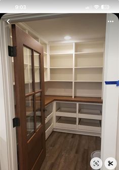 an empty walk in closet with wooden floors