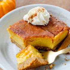 a slice of pumpkin pie on a plate with a scoop of ice cream in the middle